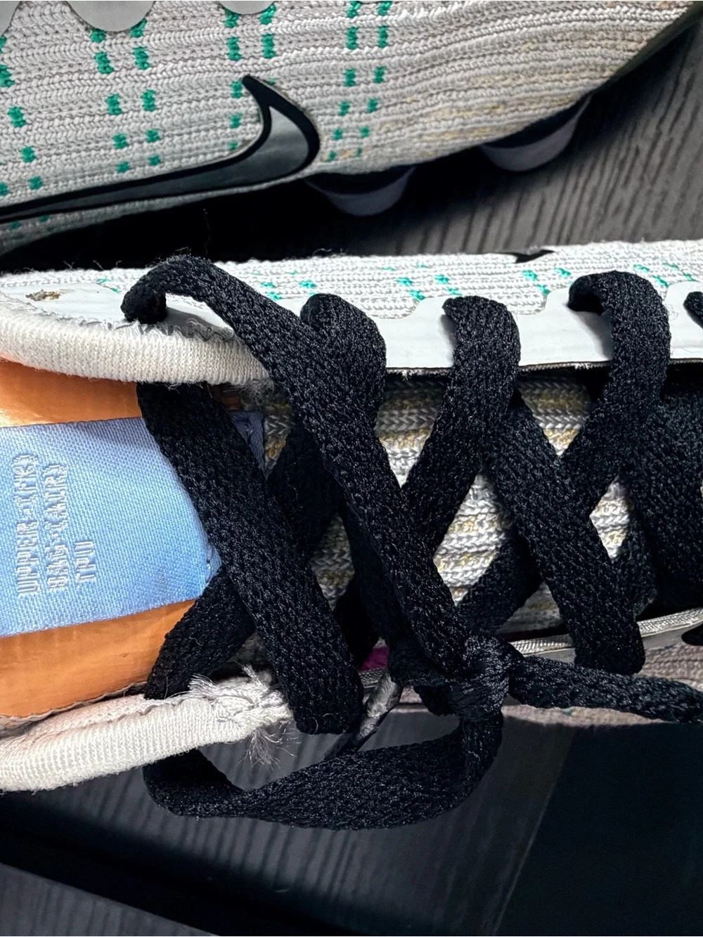 Nike Men’s White Knit Sneakers with Black Accents and Teal Dots
